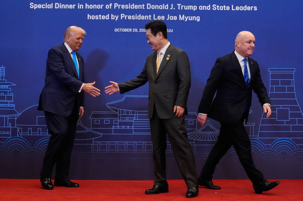 ترامب يصافح الرئيس الكوري الجنوبي لي جاي ميونغ خلال حفل عشاء في جيونغجو (اب)