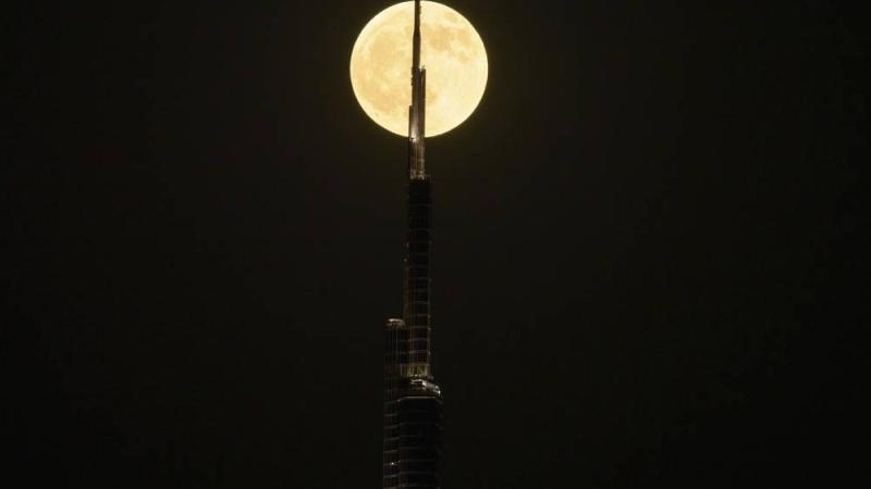 A "blood moon" is seen behind Burj Khalifa on Sunday, Sept. 7, 2025, ahead of a total lunar eclipse as the Sun, Earth and Moon align perfectly in Dubai, United Arab Emirates. (AP Photo/ Fatima Shbair)