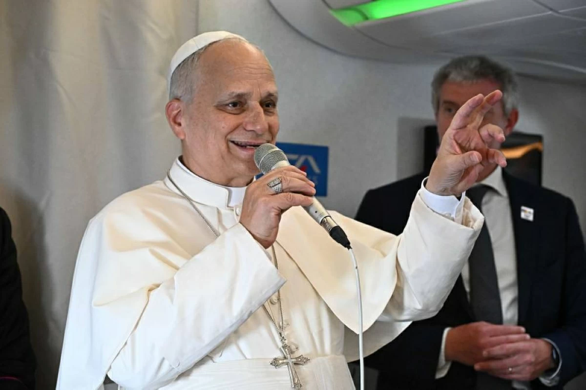 Pope Leo XIV answers journalists' questions during his flight from Yaounde, Cameroon to Luanda, Angola, Saturday, April 18 2026.  (Luca Zennaro/Pool Photo via AP)