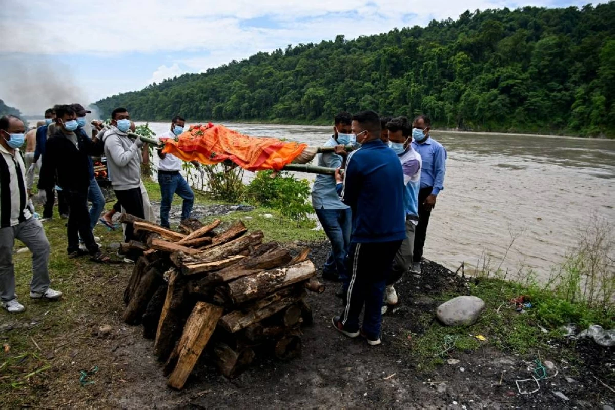 Mourners cremate the body of deceased victim Ayush Khadka, after flash floods in Nepal's Chitwan district on August 31, 2026. Nepal was burying on August 31 some of the hundreds of bodies retrieved after a deadly, tsunami-like flood crashed through the Himalayan region, sweeping away villages and leaving thousands still missing. Distraught families have packed rescue stations and hospitals in search of their missing relatives, while others have faced the grim task of identifying bodies at overflowing morgues. (Photo by Prakash MATHEMA / AFP)