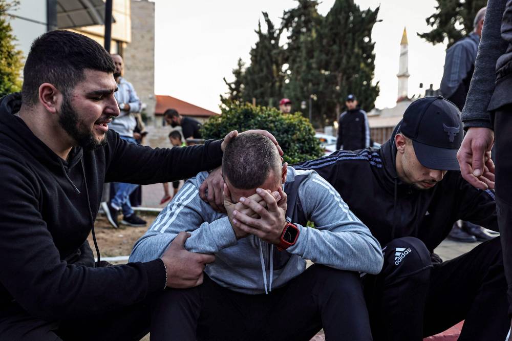 فلسطيني يبكي خلال تشييع زميله في قلقيلية (ا ف ب)