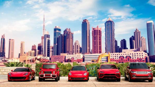 Fascinating cityscape with expensive luxury red cars in the parking lot against the backdrop of Dubai towers.