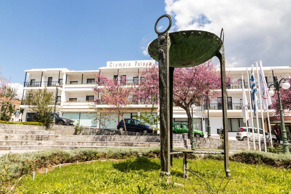 ARCHAIA OLYMPIA, GREECE - Apr 18, 2019: Replica of the Olympic flame cauldron altar in front of the Olympia Palace