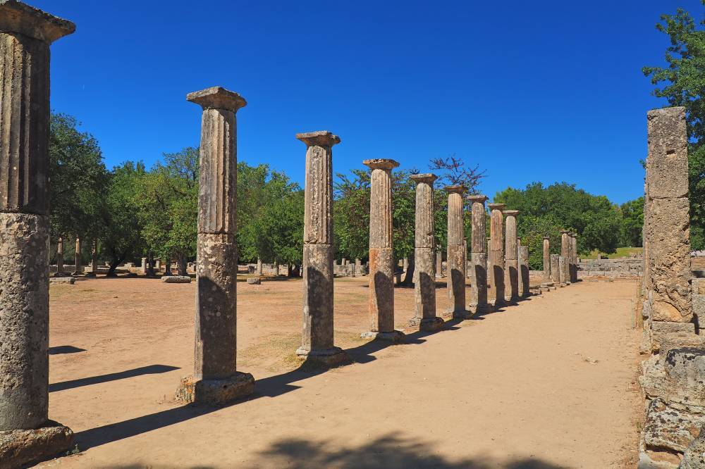 OLYMPIA, GREECE. SEPTEMBER 26, 2021. View of a row of columns of the famous Palaistra, wrestling school, at the archaeological site of ancient Olympia, a UNESCO World Heritage Site, in western Pelopon