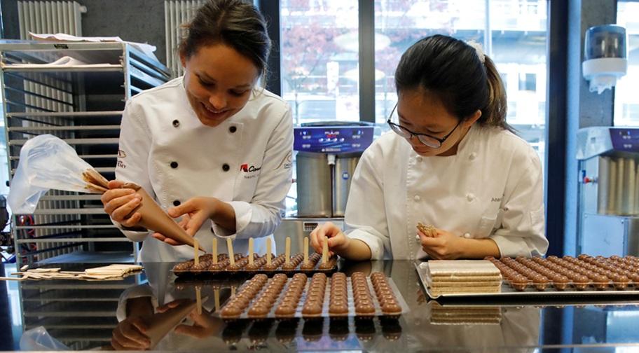 ممثلتان لشركة باري كاليبو تعدّان الشوكولاتة في زيورخ