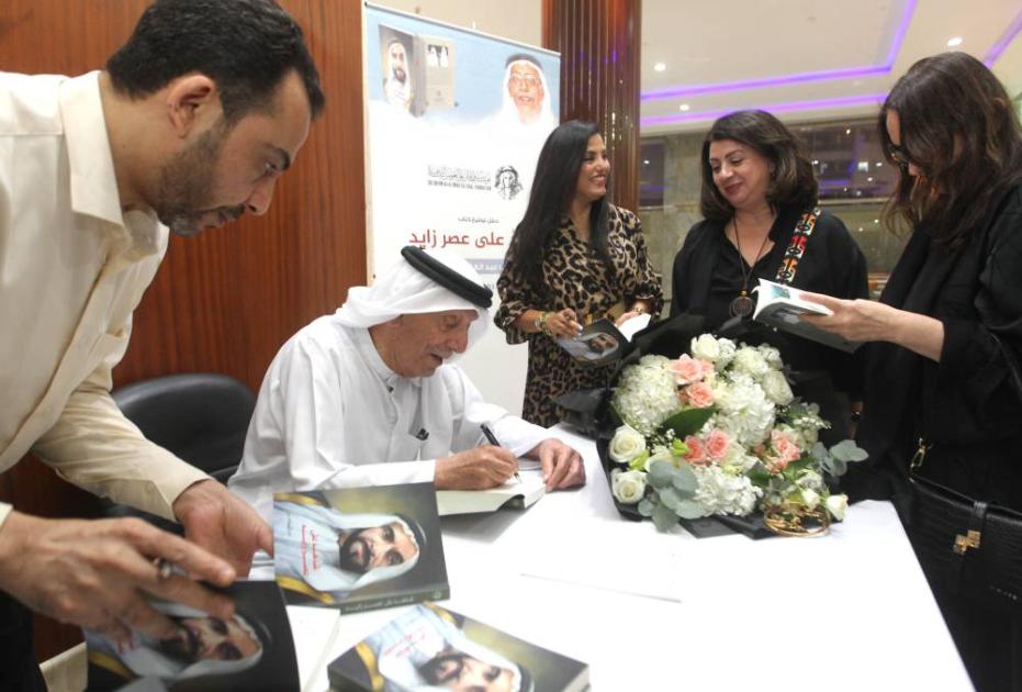 Abdul Ghaffar Hussein signs his book “Witness to the Era of Zayed”