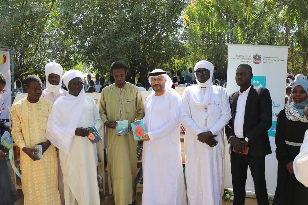 راشد الشامسي خلال توزيع الكتب