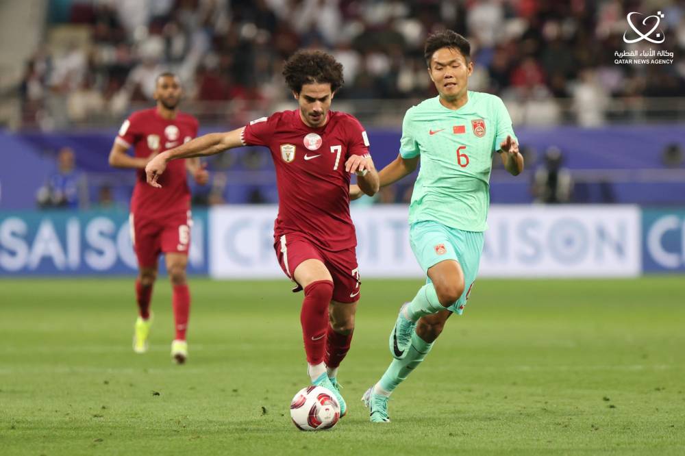منتخب قطر خلال المباراة مع الصين في الدور الأول