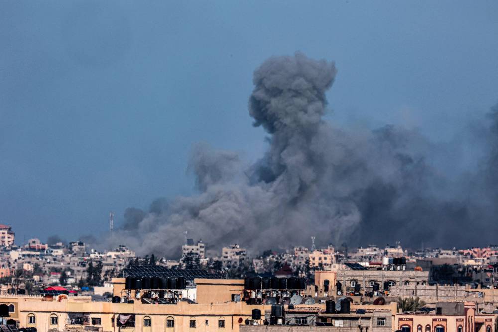 A picture taken from Rafah shows smoke billowing during Israeli bombardment over Khan Yunis in the southern Gaza Strip on February 9, 2024, amid continuing battles between Israel and the Palestinian militant group Hamas. (Photo by SAID KHATIB / AFP)