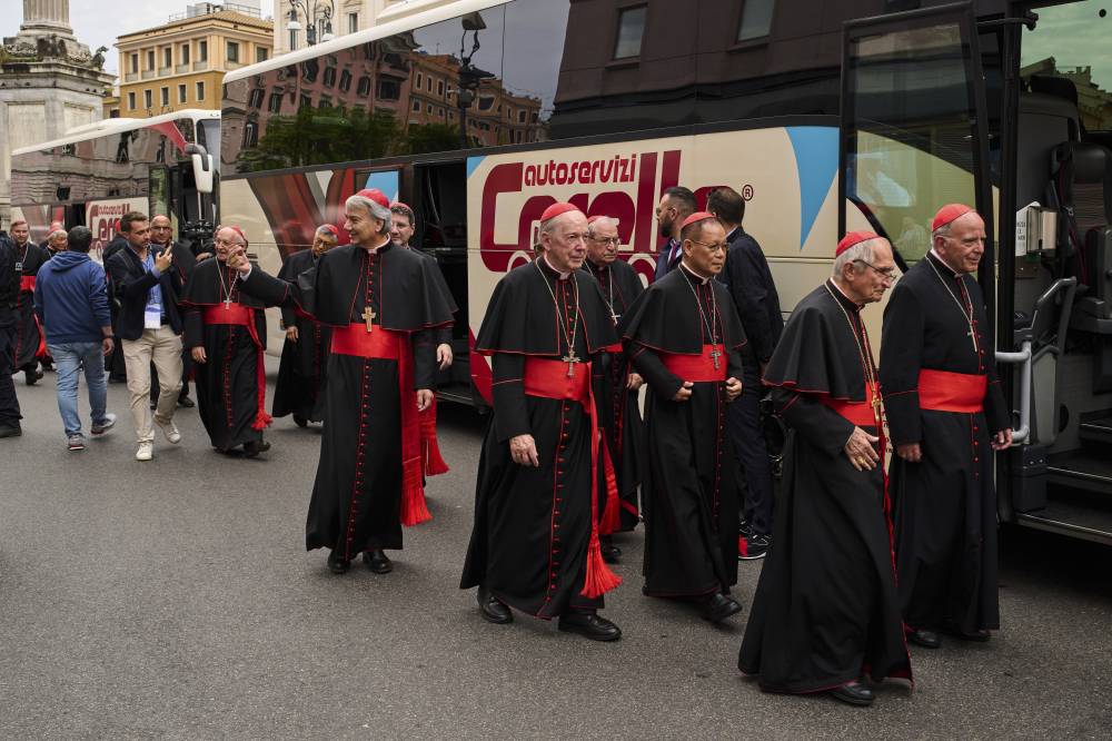 Cardinals walk outside St. Mary Major Basilica, where Pope Francis is buried, Sunday, April 27, 2025. (AP Photo/Bernat Armangue)