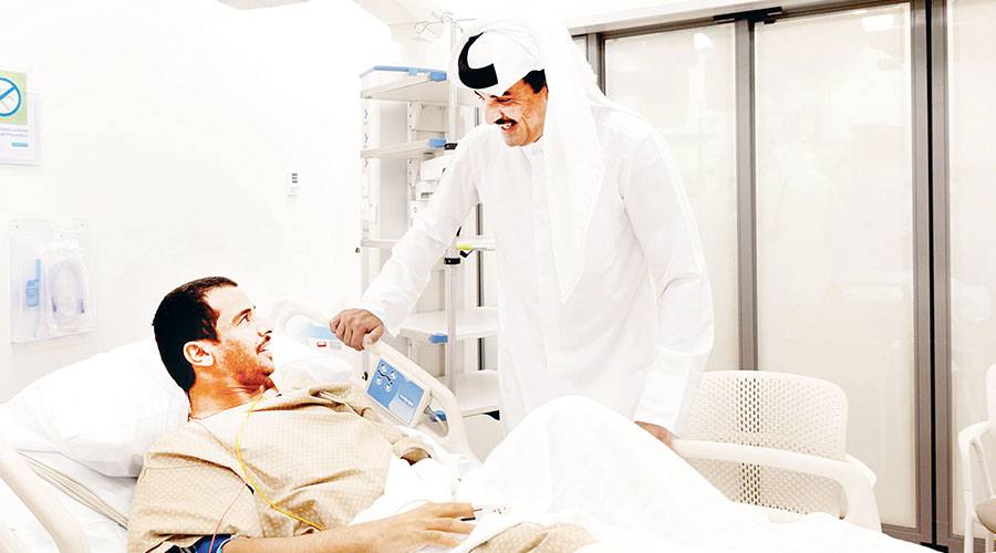 أمير قطر الشيخ تميم بن حمد يعود أحد المصابين في العدوان الإسرائيلي الأخير (قنا)