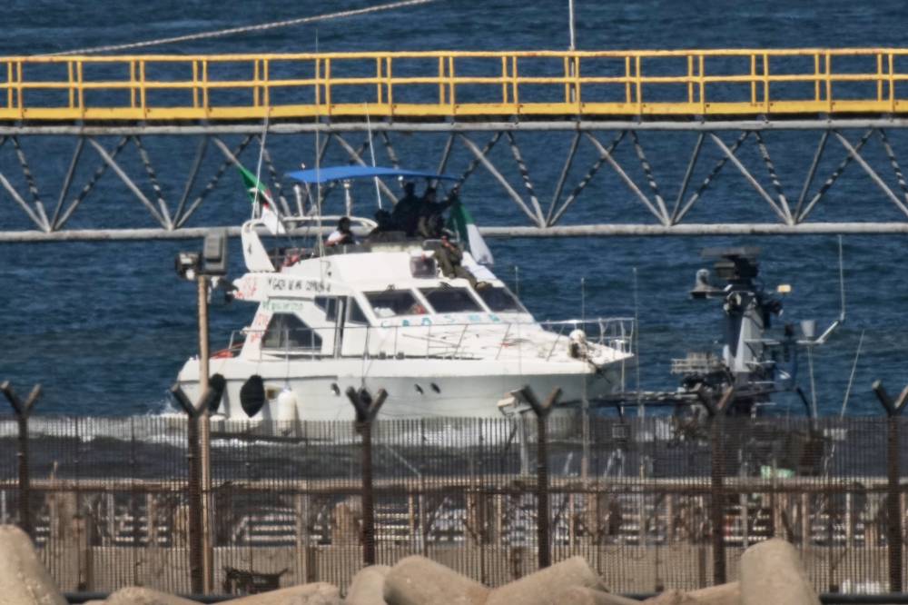 Israeli navy soldiers sail one of the Gaza-bound civilian flotilla Sumud's boats into the port of Ashdod, Israel, Thursday, Oct. 2, 2025, after it was intercepted off the Gaza coast. (AP Photo/Leo Correa)