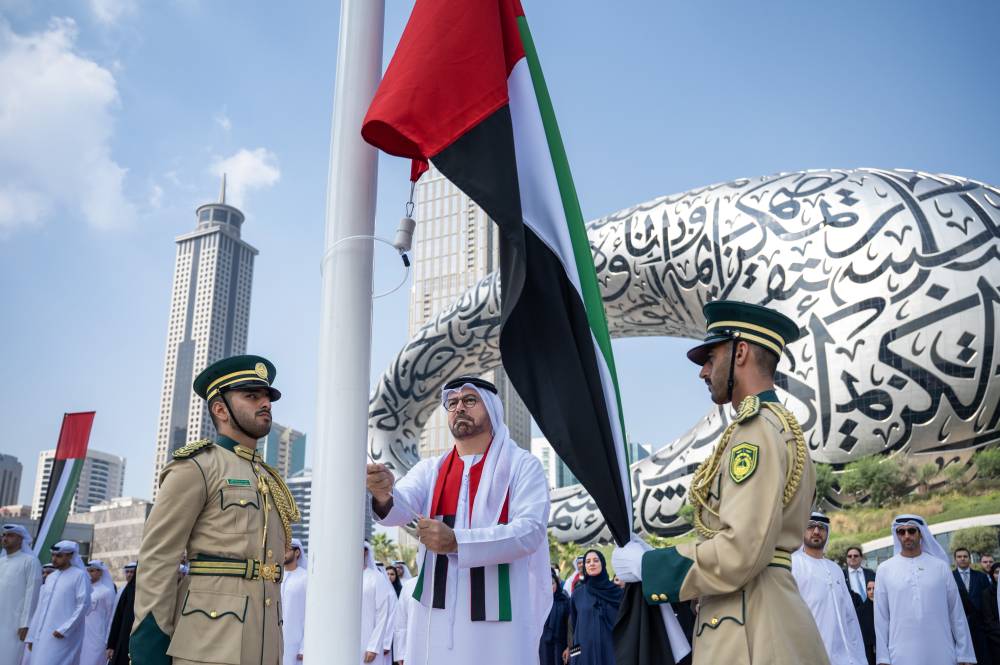محمد القرقاوي يرفع العلم أمام متحف المستقبل 