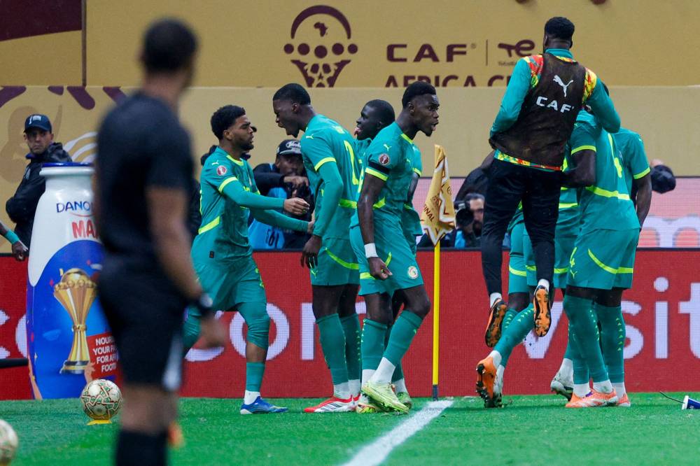 Senegal players celebrate after their first goal during the Africa Cup of Nations (CAN) final football match between Senegal and Morocco at the Prince Moulay Abdellah Stadium in Rabat on January 18, 2026. (Photo by Abdel Majid BZIOUAT / AFP)