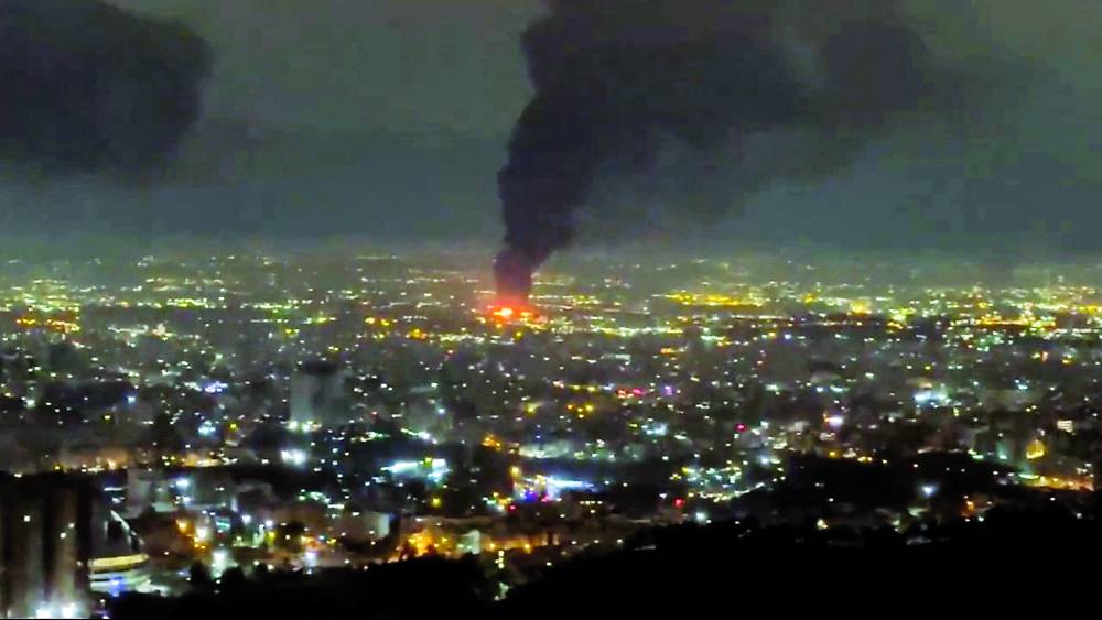 عمودان من الدخان يتصاعدان عقب غارات جوية في طهران(رويترز)